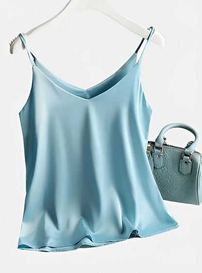 Light blue satin camisole top with thin straps and matching textured handbag